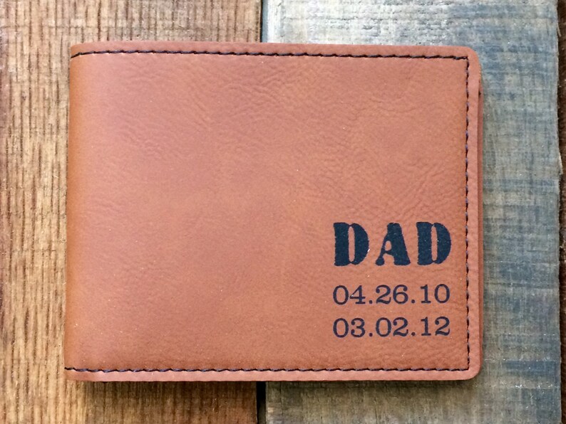 May include: Brown leather wallet with the word "DAD" and the dates "04.26.10" and "03.02.12" embossed on the front.