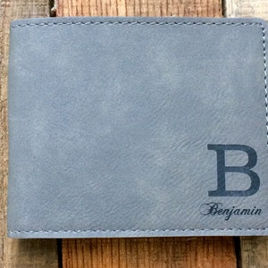 May include: A gray leather wallet with a large black letter "B" and the name "Benjamin" engraved on the front.