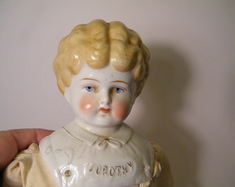 Hertwig China Head Blonde Doll Dorothy, Antique late 1900 to 1907 collectible Pet Name Doll in original clothing, has patent app d mark,