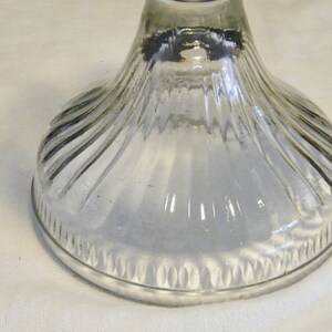 May include: Clear glass base with a fluted design and a scalloped edge.