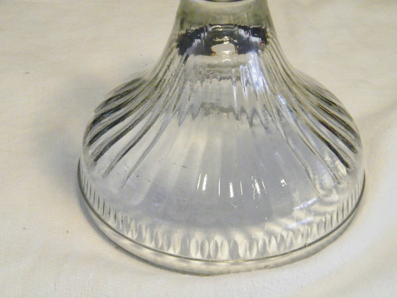 May include: Clear glass base with a fluted design and a scalloped edge.