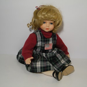 Vintage Porcelain Doll in Sitting Position, Sweet Little Girl in Plaid Jumper and Red Sweater, Gently displayed, No box or COA, No Markings