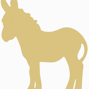 May include: A cutout of a donkey, a farm animal, made of wood. The donkey is standing on all four legs and is facing to the right. The donkey is a light brown color.