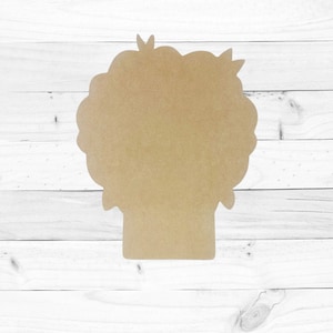 May include: A brown wooden cutout of a person with a large, curly hairstyle. The cutout is blank and ready to be painted or decorated.