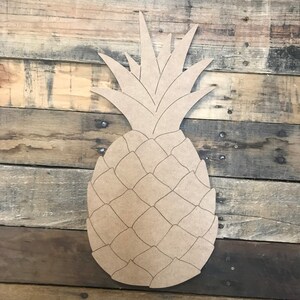 May include: A wooden cutout of a pineapple with a detailed design. The pineapple is brown and has a textured surface.