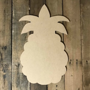 May include: Unpainted wooden pineapple cutout, perfect for crafting and decorating. The cutout is shaped like a pineapple with a detailed top and leaves.