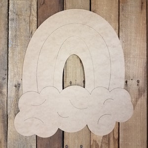 May include: A wooden cutout of a rainbow with a cloud underneath. The rainbow has three arches and the cloud has a textured design.