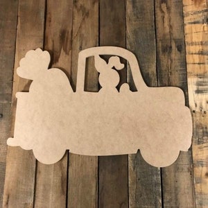 May include: Unfinished wooden cutout of a pickup truck with a person in the driver's seat and a large bundle of flowers in the bed of the truck.
