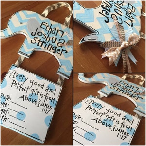 May include: A blue and white wooden elephant shaped sign with the text "Ethan Joshua Stringer" and "Every good and perfect gift is from Above James 1:17". The sign has a space to write in the date, time, weight, and length of the baby.