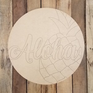 May include: A wooden round sign with the word "Aloha" in a cursive font and a pineapple design. The sign is unfinished and ready to be painted.
