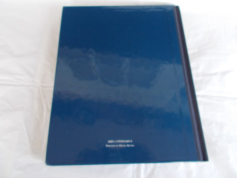 May include: A dark blue hardcover book with the text "ISBN 1-57793-403-3 Printed in Hong Kong" on the back cover.