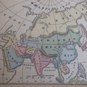 May include: A vintage map of Asia with hand-drawn borders and color-coded regions. The map shows the Chinese Empire, India, Arabia, and surrounding countries. The map is printed on paper with a light brown background.