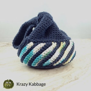 May include: A dark blue crocheted bag with a white, yellow, and blue striped bottom.