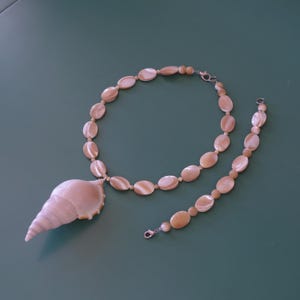 May include: A handmade, wooden serving tray with a natural finish. The tray features a rectangular shape with raised edges and integrated handles. The wood grain is visible, showcasing the tray's craftsmanship. Dimensions are approximately 16 inches long and 10 inches wide.