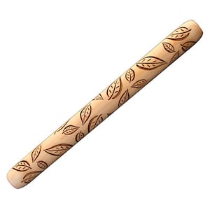 May include: A wooden rolling pin with a leaf pattern carved into the surface. The rolling pin is light brown in color.