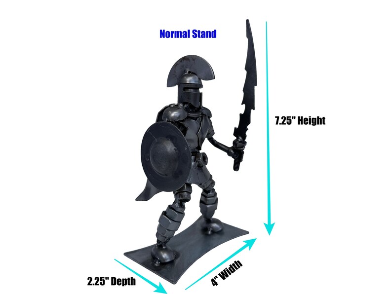 May include: A metal sculpture of a warrior holding a sword and shield. The sculpture is 7.25 inches tall, 4 inches wide, and 2.25 inches deep. The warrior is made of recycled metal and has a dark gray finish.