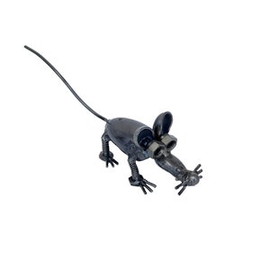 May include: A metal sculpture of a mouse made from recycled metal parts. The mouse is gray and has a long tail.
