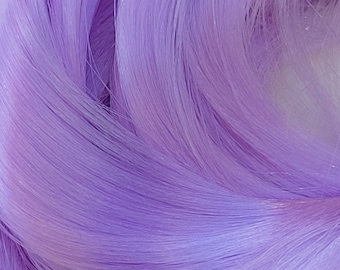 May include: A close-up of a bundle of soft, light purple hair extensions. The hair is smooth and silky, with a slight sheen.