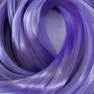 May include: A close-up of a bundle of soft, silky, lavender-colored yarn.