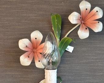 May include: White metal wall sconce with a clear glass light bulb and two pink metal flowers. The sconce has a price tag that says "90".