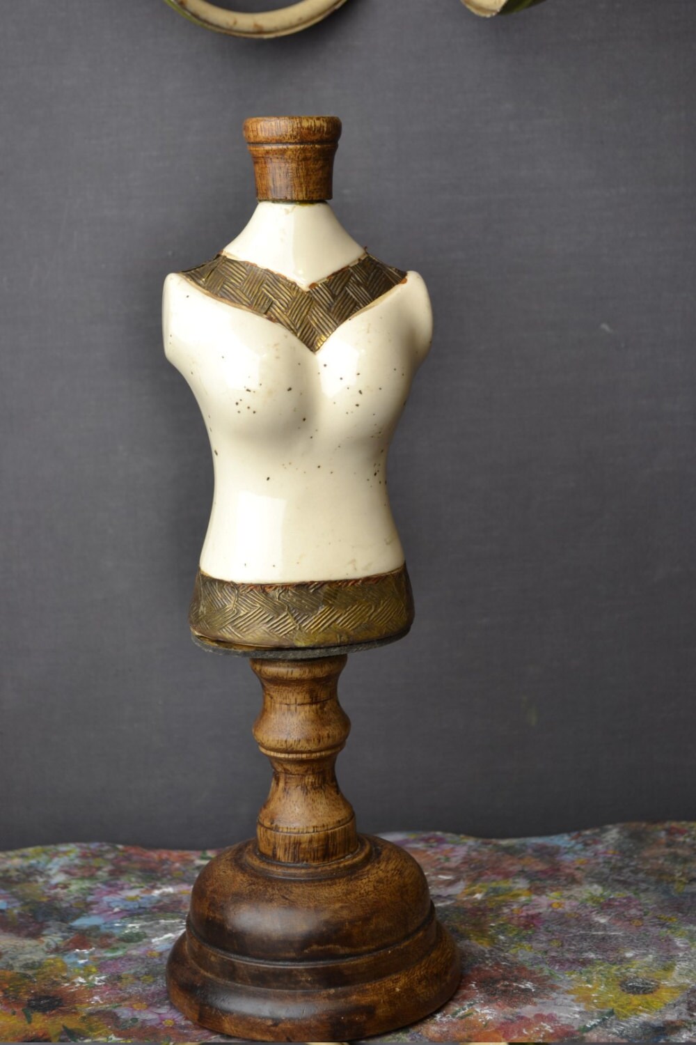 Small mannequin made, wooden stand, porcelain body and metal decoration.