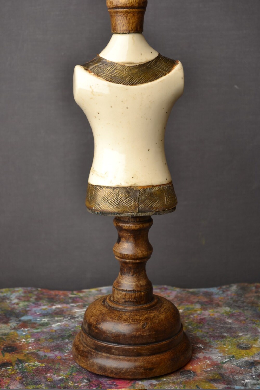 Small mannequin made, wooden stand, porcelain body and metal decoration.