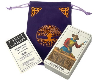 May include: A tarot card deck with a purple drawstring bag featuring a gold tree of life design. The deck includes a booklet and cards with the text "LE BATELEUR". The bag has gold corner designs.