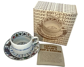 May include: A white ceramic fortune teller cup and saucer set with zodiac symbols and the text "Once this cup will show it". The set includes a box with the words "Fortune Teller Cup & Saucer".