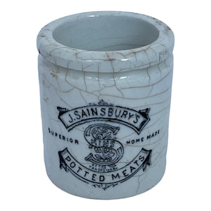 May include: White ceramic jar with a black and white label that reads "J. Sainsbury's Superior Home Made Potted Meats". The jar has a crackled glaze.