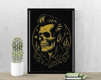May include: A framed black and gold print featuring a stylized skull with a pompadour hairstyle. The skull is surrounded by a circular design with stars and flames. The artwork is displayed on a wall next to a potted cactus.