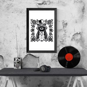 May include: Black and white framed art print featuring a raccoon wearing a top hat and monocle, surrounded by decorative gears. A black vinyl record with a red label sits on a black table, along with headphones and a small radio.