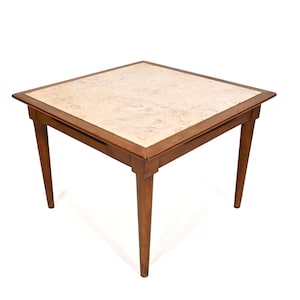 May include: A square wooden side table with a light-colored, patterned top. The table has a dark brown frame and four tapered legs. The top measures approximately 24 inches by 24 inches.