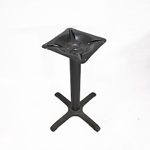 May include: A black metal table base with a square top and a central column. The base has a four-pronged foot design. The table base is designed to support a tabletop and is suitable for commercial or residential use.