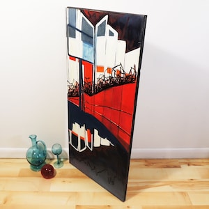 May include: Abstract painting on canvas with a red, white, and black color scheme. The painting features geometric shapes and lines, creating a sense of movement and depth.