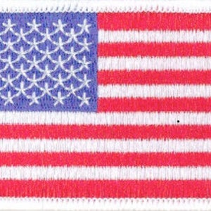 May include: A small embroidered American flag patch with red and white stripes and a blue field of white stars.