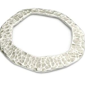 May include: A silver octagonal ring with a hammered texture.