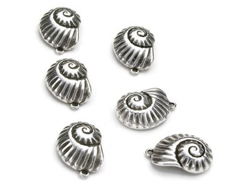 May include: Six silver seashell charms with a spiral design. The charms are about 1 inch in diameter and have a hole at the top for attaching to a necklace or bracelet.