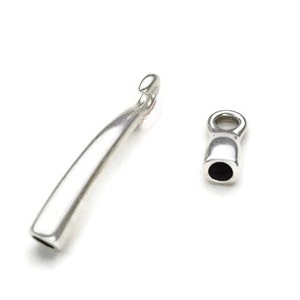 May include: Two silver metal jewelry end caps. One end cap is a long, curved, hook-shaped piece. The other end cap is a small, round, barrel-shaped piece with a small loop at the top.