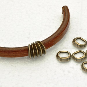 Ribbed Oval Spacers fits 10 x 6mm Licorice Leather Cord - Antique Brass