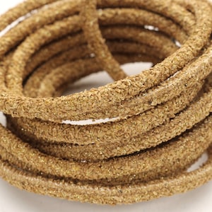 May include: A roll of gold glitter cord, a decorative trim for crafts and home decor projects.