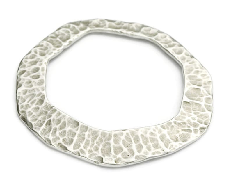 May include: A silver octagonal ring with a hammered texture.