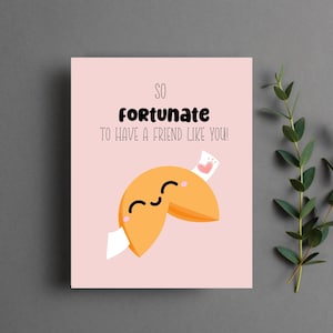 May include: A pink card with the text "So fortunate to have a friend like you!" and a cartoon fortune cookie with a smiling face and a heart on the fortune paper.
