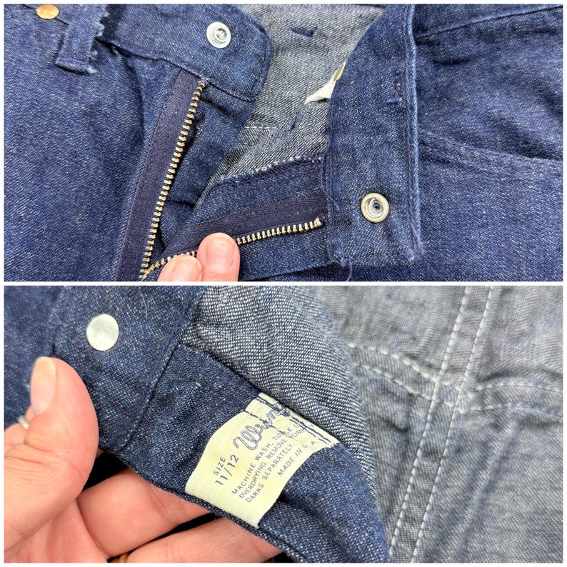 May include: Close-up of dark blue denim jeans. The image shows the zipper, button closure, and the interior label with size 11/12. The jeans appear to be vintage, with a classic design and construction.
