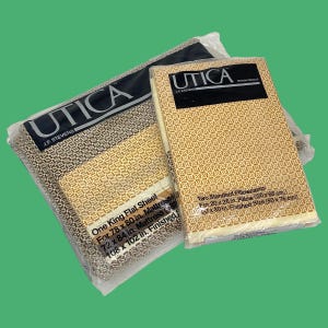 May include: Two packages of Utica brand bed linens. One package contains a king flat sheet for a 78 x 80 inch mattress. The other package contains two standard pillowcases, each 20 x 26 inches. The linens have a geometric pattern.