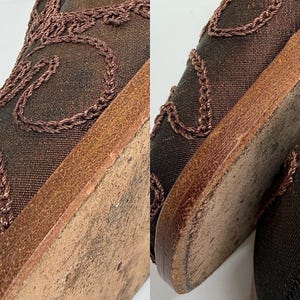 May include: Close-up of a pair of brown shoes. The shoes have a dark brown mesh upper with decorative stitching and a leather sole. The soles show signs of wear.