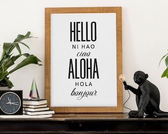 May include: A framed print with the words "HELLO", "NI HAO", "CIAO", "ALOHA", "HOLA", and "BONJOUR" in black text on a white background. A black monkey lamp is on a black dresser with sheet music.