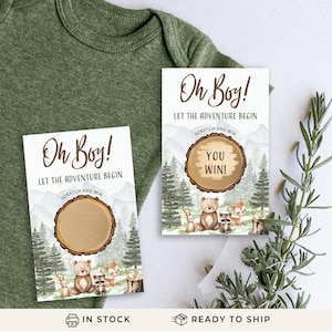 May include: Two woodland themed baby shower scratch off cards with the text "Oh Boy! Let the adventure begin" and a scratch off area with a woodland animal design. The card on the right has the text "You Win!" revealed.