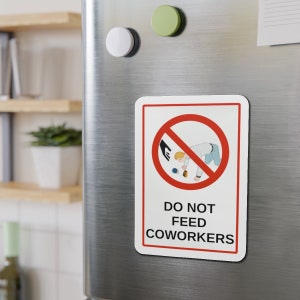 May include: A white sign with red and black accents on a stainless steel refrigerator. The sign has a red circle with a diagonal line through it and a black hand reaching into the circle. A cartoon person is on the ground reaching for something. The sign says "Do Not Feed Coworkers".