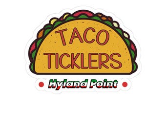 May include: A sticker featuring a cartoon taco design. The taco is yellow with red text that reads "TACO TICKLERS." Below the taco is the text "Hyland Point" in green and red. The sticker has a white border.