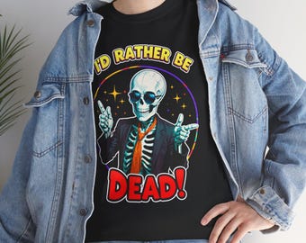 May include: Black t-shirt featuring a skeleton wearing sunglasses, a suit, and an orange tie. The text "I'D RATHER BE DEAD!" is displayed in a colorful, circular design. The skeleton is giving a double peace sign.